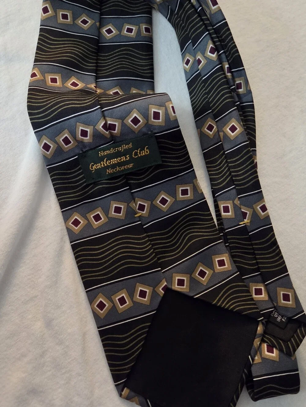 Black Geometric Stripe Men's Tie with Gold and Purple Accents